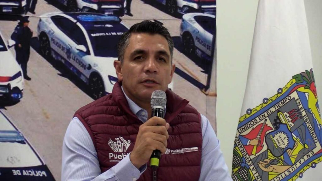 Funcionario público hablando en conferencia de prensa.